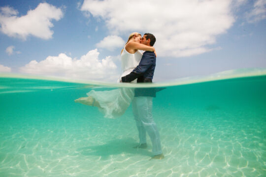 Couple embracing in turquoise ocean water