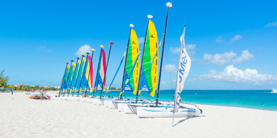 Hobie Cat sailboats on the wide white sand beach fronting Club Med