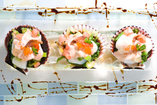 Scallop dish with caviar on a plate