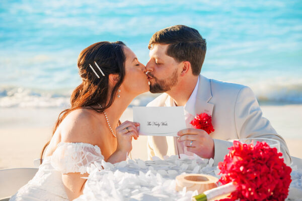 Couple kissing at their elopement on Grace Bay Beach