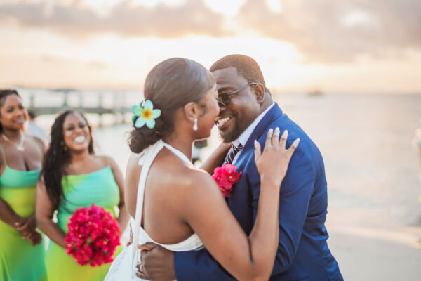 Newlywed couple on Grace Bay Beach at sunset.