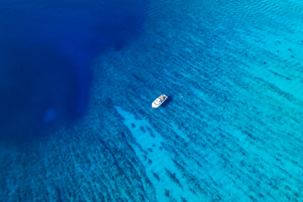 Overhead aerial view of a dive boat near the wall at the barrier reef off Providenciales.