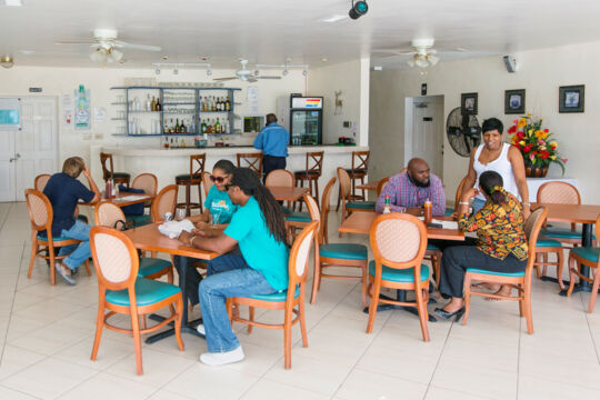 Patrons and indoor dining area at Dolphin Grill on South Caicos