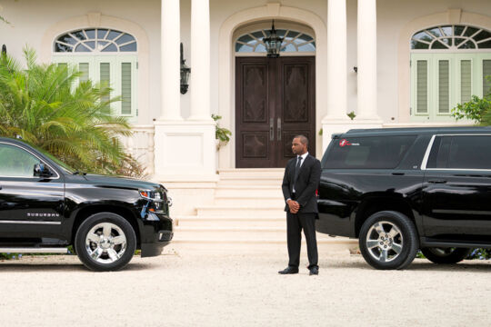 Large Chevrolet Suburbans parked outside a luxury villa in Turks and Caicos