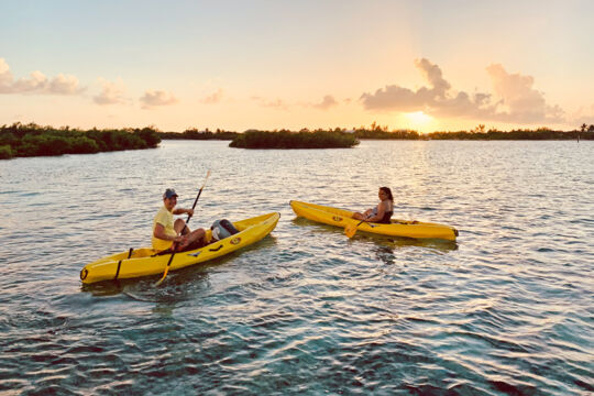 People kayaking at sunset off Providenciales. 