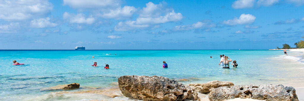 Cruise ship guests enjoying the ocean at Governor's Beach