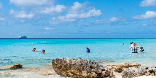 Cruise ship guests enjoying the ocean at Governor's Beach