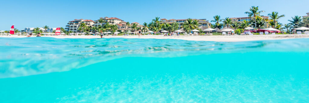 Over-under photo of Grace Bay Club and turquoise ocean water