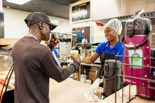 Woman serving coffee at a deli in Turks and Caicos.