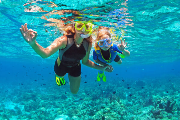 Mother and daughter snorkeling on a Caribbean reef.