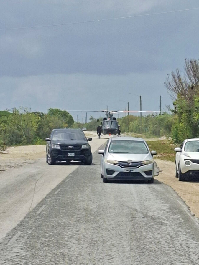 A police helicopter landing on a road in Turks and Caicos.