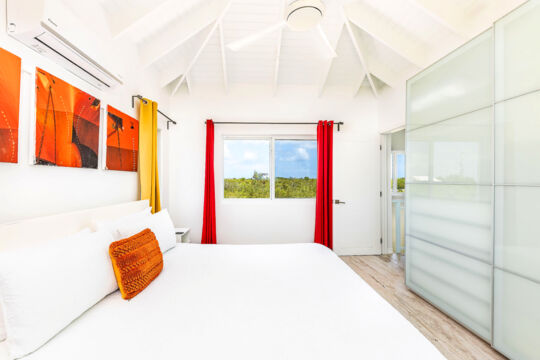 Villa bedroom with view of tropical forest.