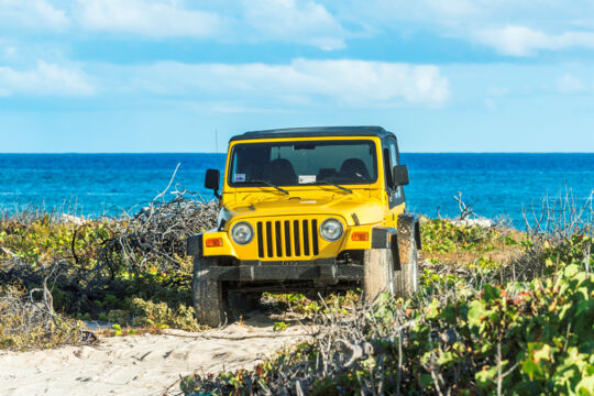 Yellow Jeep Wrangler parked on the coast in South Caicos 