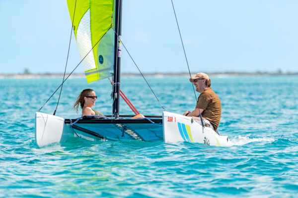 Couple sailing a Hobie Cat sailboat at Grace Bay