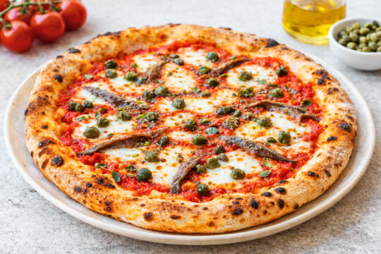 Pizza with capers and anchovies. 