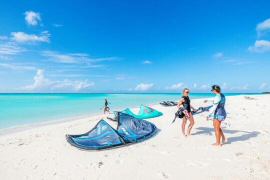 Setting up kiteboarding equipment on a beach in the Turks and Caicos