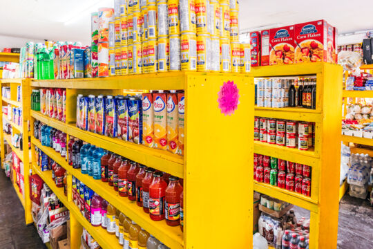 Juices and canned goods on shelves in a grocery store