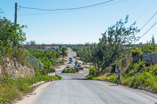 Person riding a bike on an inland road in Kew Town, Providenciales