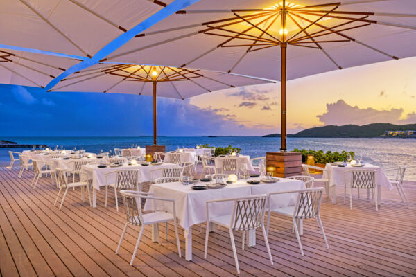Waterfront restaurant on a dock with a beautiful sunset.