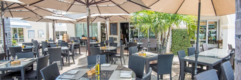 Outdoor seating at Le Bouchon Village restaurant in Grace Bay