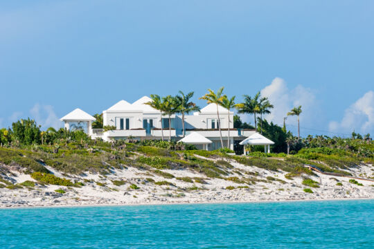 Luxury villas behind sand dunes on Long Bay Beach