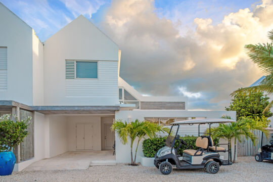 Electric beach cart parked outside of a luxury villa on Providenciales. 