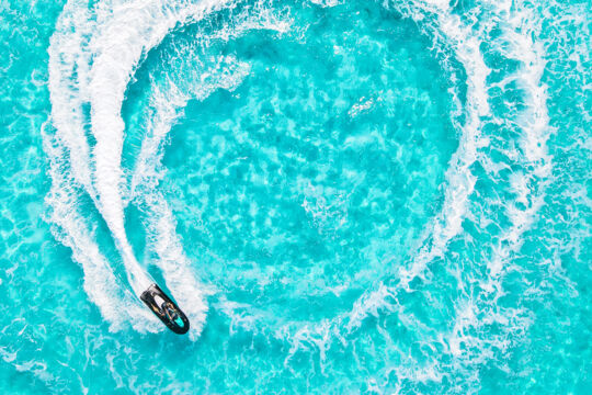 Overhead view of jet ski on clear turquoise water in the Turks and Caicos