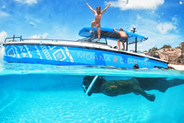 Overunder view of Moana Charters boat in the clear water of the Turks and Caicos