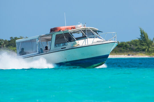 Moving passenger ferry boat in turquoise water
