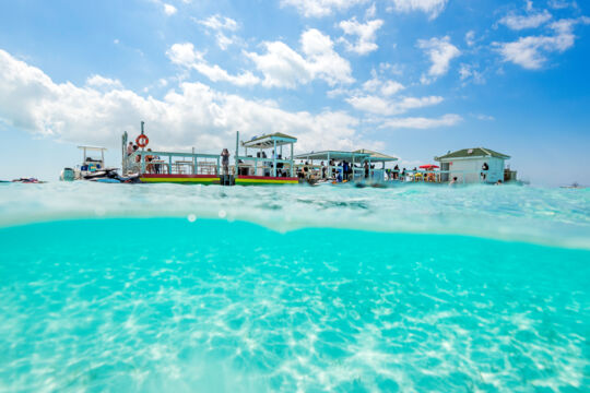 Shallow and clear ocean water near Noah's Ark floating bar in the Turks and Caicos