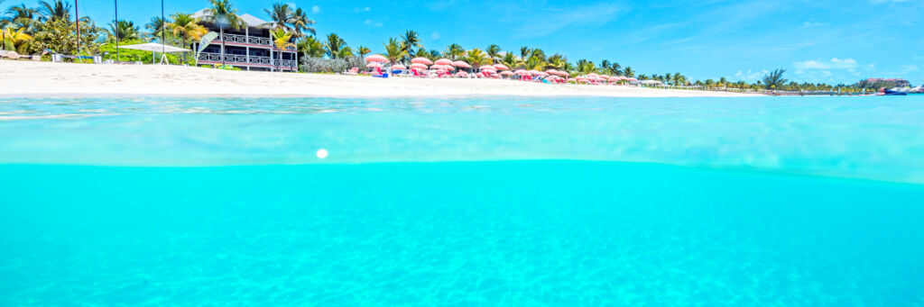 Over under photo showing the beach and ocean at Ocean Club