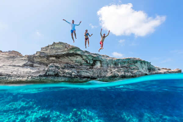 Three people cliff jumping at West Caicos