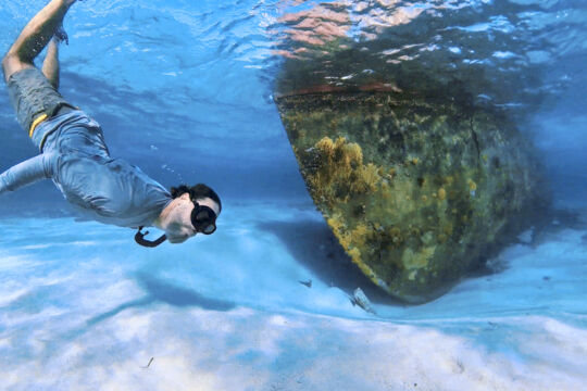 Snorkeler at a shipwreck in the Turks and Caicos