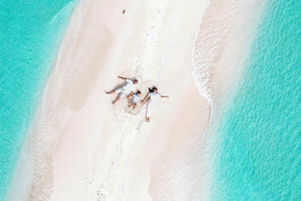 Drone photo of a family with a toddler on a sandbar in Turks and Caicos