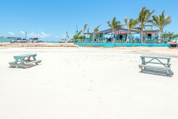 Beach and picnic tables at Omar's Beach Hut in the Turks and Caicos