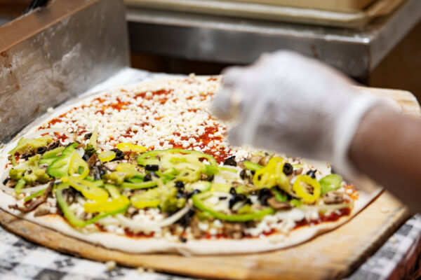A pizza being made at Pizza Pizza.
