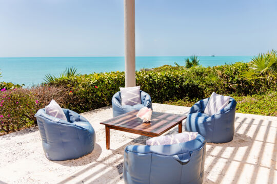 Outdoor patio with beanbags overlooking the ocean.