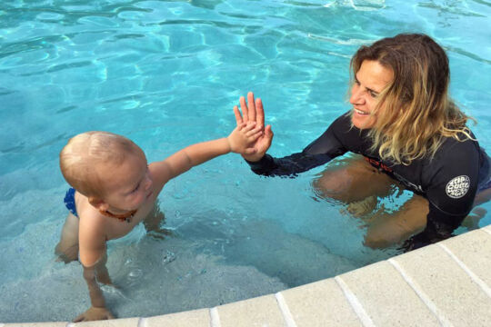 Swim instructor with a toddler in a pool