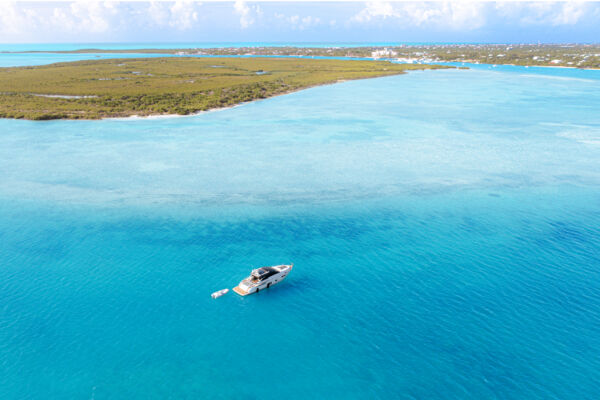Yacht anchored in turquoise water near Mangrove Cay, Turks and Caicos.