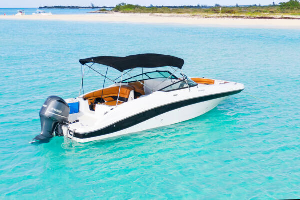 Charter boat anchored off a private island with turquoise water. 