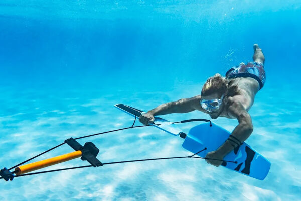 Man subwinging in turquoise water.