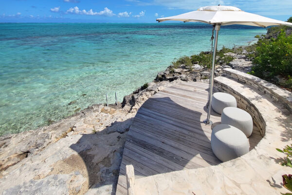 Umbrella and ocean fronting the Rock House project in the Turks and Caicos