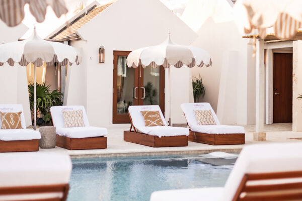 Loungers surrounding a pool at a luxury resort spa. 