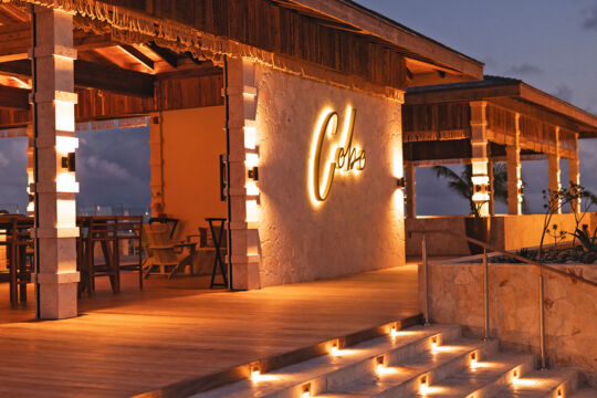 Exterior of Cobo Bar & Grill on South Caicos at twilight.