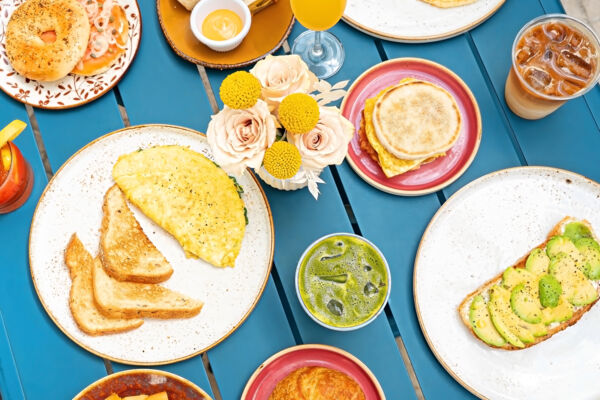 Omelet with toast, breakfast sandwich, avocado toast, coffee and matcha, and bagel with smoked salmon