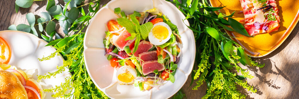 Salad with egg, tuna, lettuce, and tomato