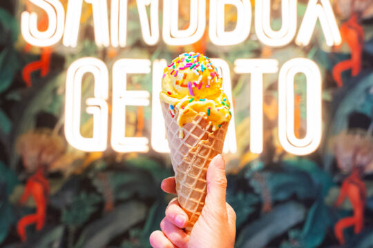 Hand holding a cone of gelato at a gelateria