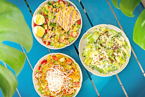 Three bowls of salad on a table