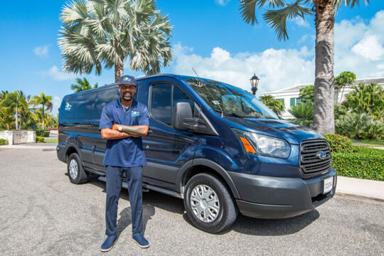 Taxi driver and taxi van parked in Grace Bay