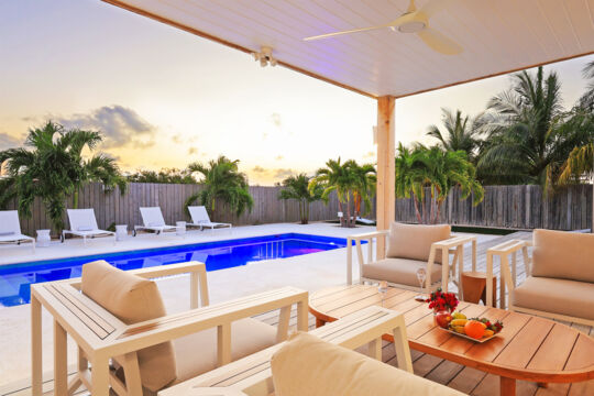 Pool deck at villa at sunset